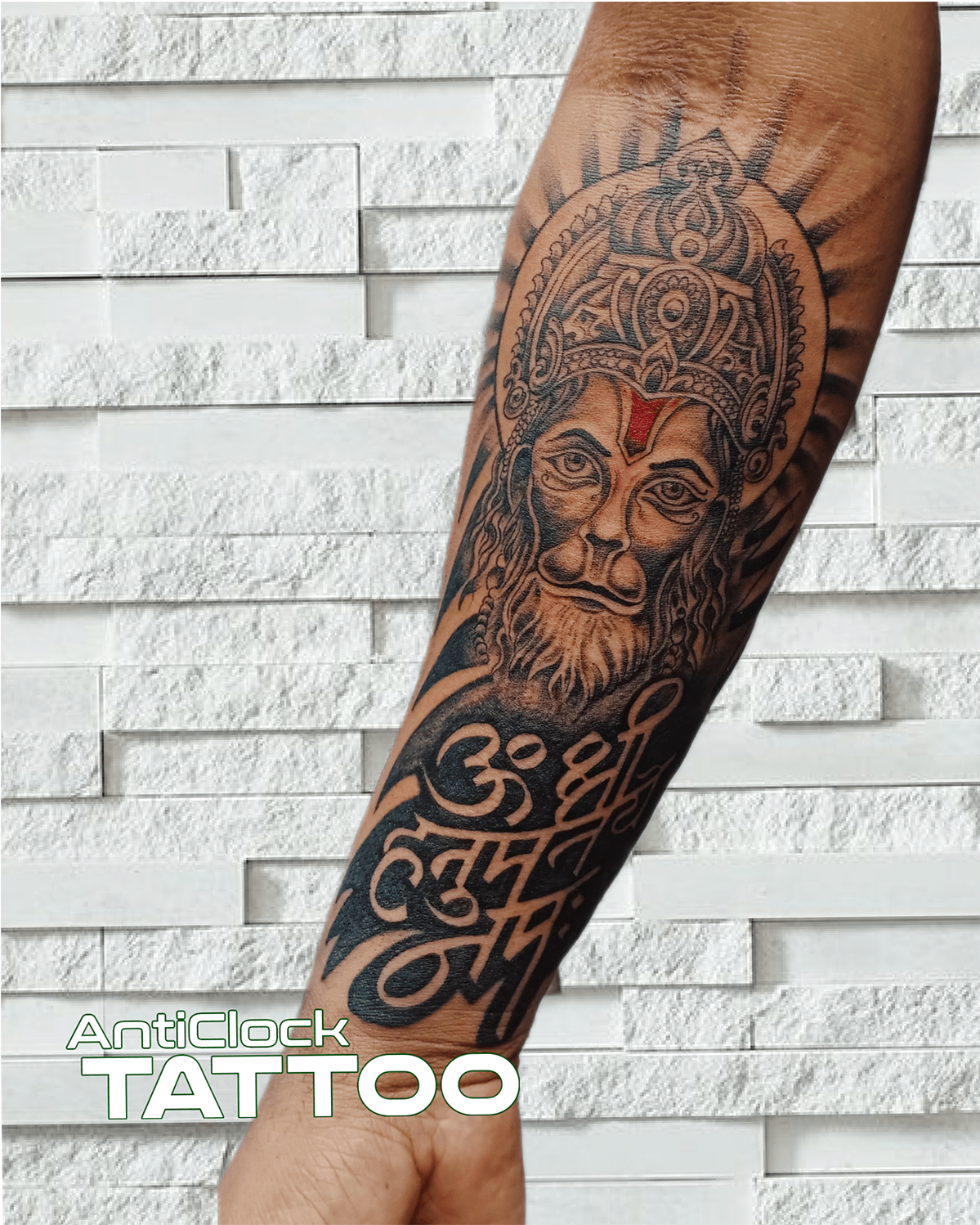 black and grey hanuman tattoo on forearm min